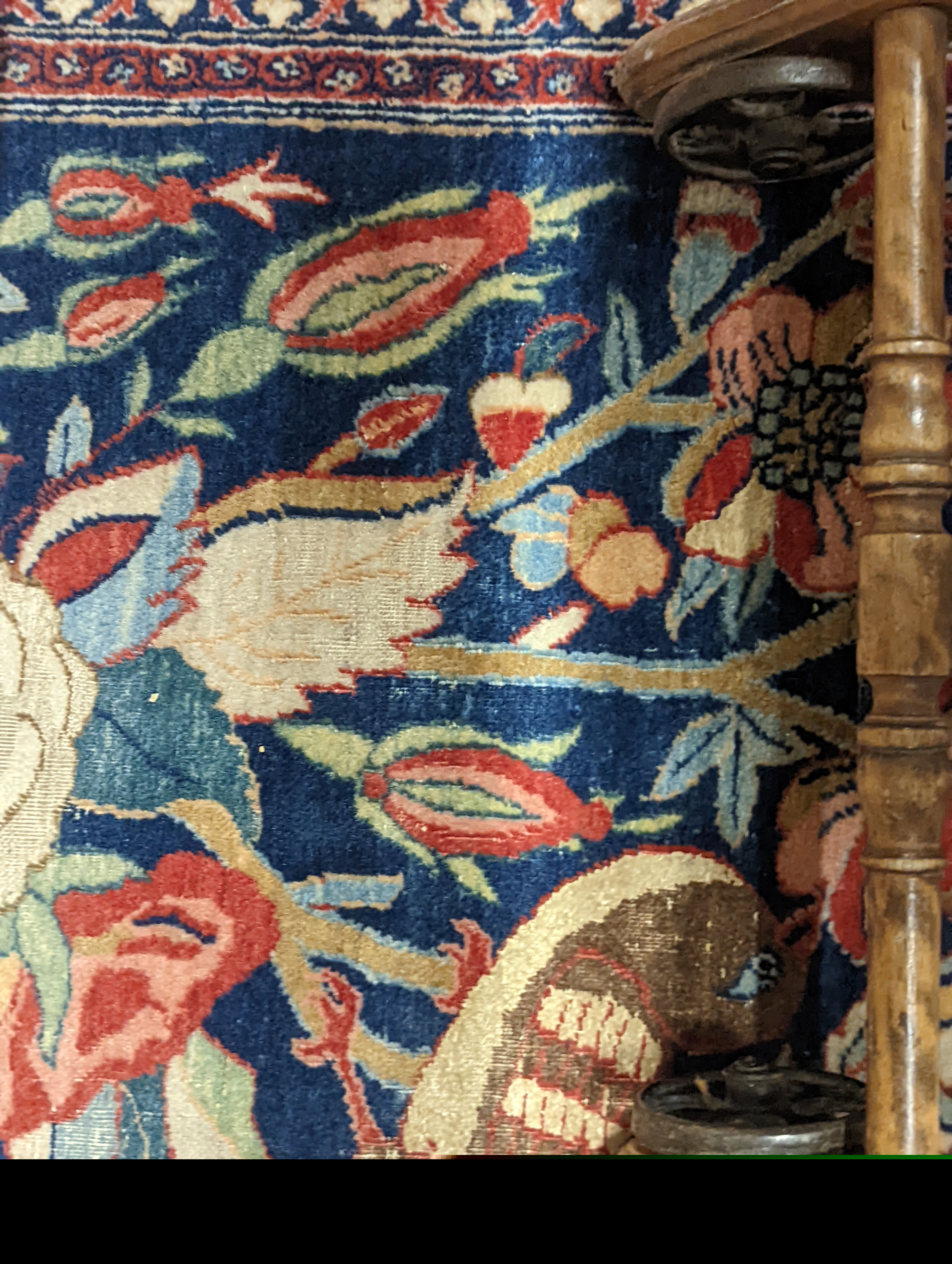 A Kirman blue ground rug woven with birds amongst flowering branches, 205 x 136cm